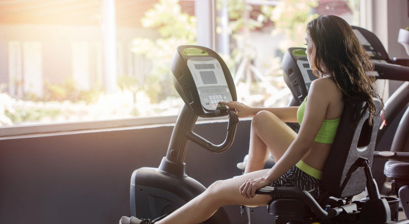 A woman on a recumbant exercise bike