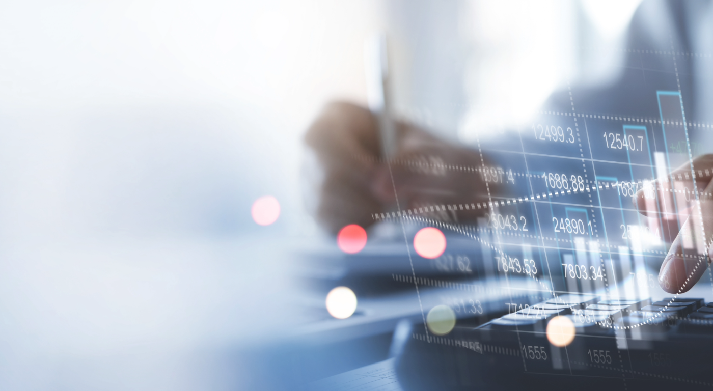 Hands using a calculator and reviewing financial charts and data overlaid on a digital interface, representing accounting and financial management.